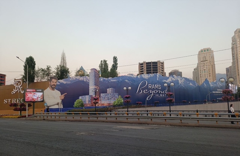 Забор, с рекламным билбордом РАМС, где будет строится 40-этажный ЖК